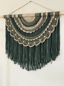 Emerald crescent macramé pattern wall hanging with layered green arcs and fringe