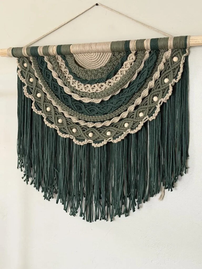 Emerald crescent macramé pattern wall hanging with layered green arcs and fringe