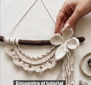 Finished floral crescent macramé pattern wall hanging with picot scallops and cotton flower on driftwood