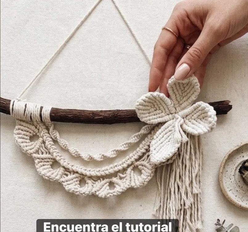 Finished floral crescent macramé pattern wall hanging with picot scallops and cotton flower on driftwood