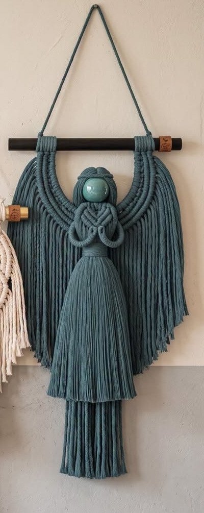 Finished teal angel macramé wall hanging with swooping wings and ceramic halo bead from the teal angel macramé pattern